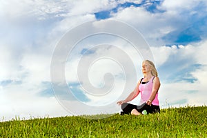 Middle-aged woman in her 40s meditating photo