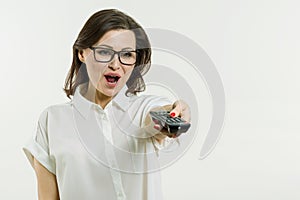 A Middle aged woman holding remote control