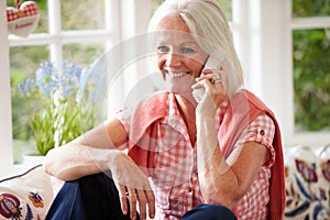 Middle Aged Woman At Home Talking On Phone