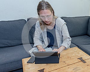 A middle aged woman at home using her laptop computer