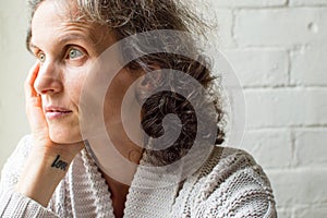 Middle aged woman looking thoughtful