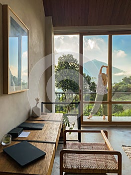 A middle-aged woman looks at the jungle and mountains