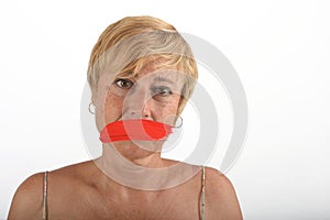 Middle aged woman with mouth covered on white