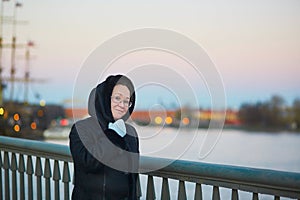 Middle aged woman on the Neva embankment in St. Petersburg, Russia