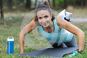 middle-aged woman performing side plank outdoors