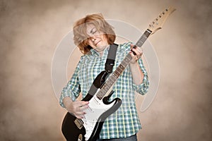 Middle aged woman playing electric guitar