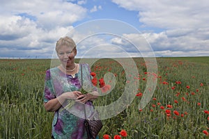 Middle-aged woman on a poppy field
