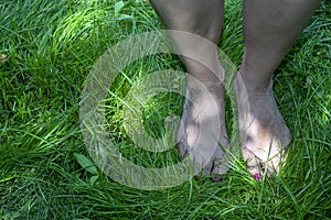 Middle aged woman practicing earthing, also referred to as grounding. photo