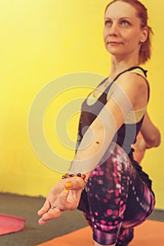 Middle aged woman practicing yoga on exercise mat