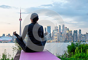 Middle-aged woman practicing yoga at the front of Toronto