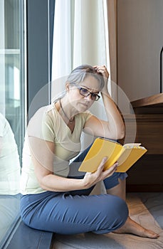 Middle aged woman reading a book