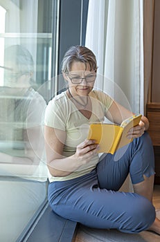 Middle aged woman reading a book