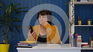 Middle aged woman reading online bad news and shocked. Sad and upset alone woman feeling serious depression about