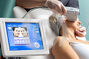 Middle aged woman receiving high intensity focused ultrasound treatment on face