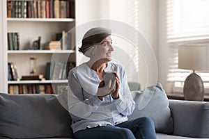 Middle-aged woman relax alone at home use smartphone