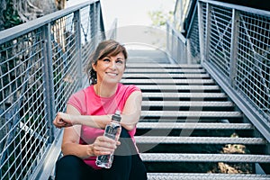 Middle aged woman relaxing after training