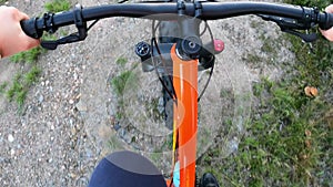 Middle-aged woman riding a fat tire bike on forest trail in summer