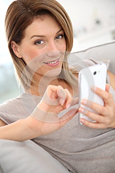 Middle-aged woman sending message