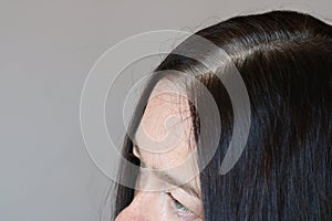 Middle aged woman Serious and Stressed effected to headache and gray hair on white background