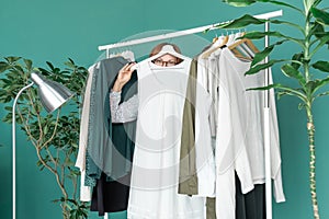 Middle aged woman shopping new dress clothes shelf green