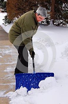 Middle aged woman shoveling