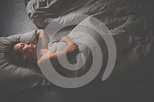 Middle-aged woman sleep in bed in the evening
