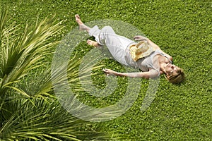 Middle Aged Woman Sleeping On Grass