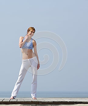 Middle aged woman smiling by the beach