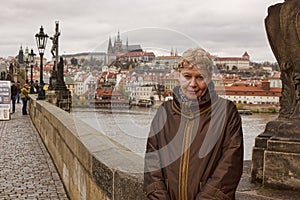 Middle-aged woman smiling on the Charles Bridge