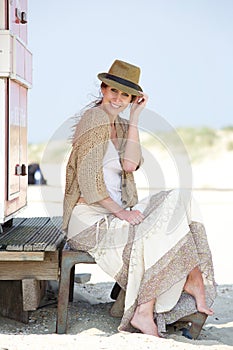 Middle aged woman smiling outdoors with hat