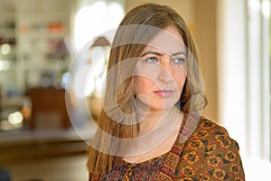 Middle-aged woman staring out with a mesmerised focused expression