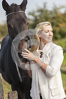 Middle Aged Woman Stroking Her Horse