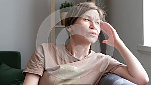 Middle aged woman suffering from head ache, pain, migrane at home