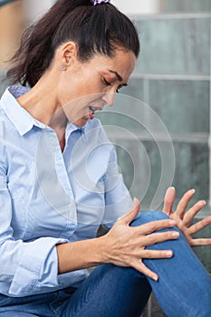 Middle aged woman suffering from knee pain