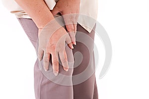 Middle aged woman suffering from knee pain, joint injury