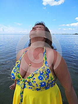 A middle-aged woman sunbathes.