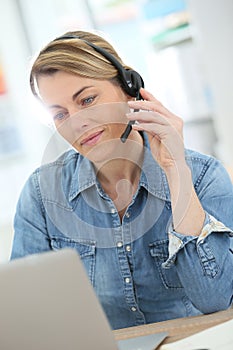 Middle-aged woman teleworking on internet photo