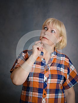 Middle aged woman thinking.