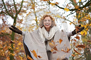 Middle Aged Woman Throwing Leaves