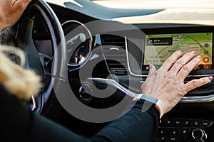 middle aged woman using car navigation system