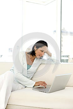 Middle-aged woman using laptop