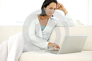 Middle-aged woman using laptop