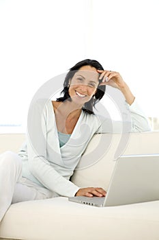 Middle-aged woman using laptop