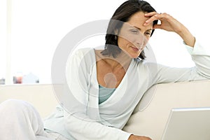 Middle-aged woman using laptop