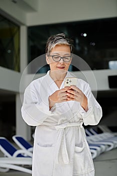 middle aged woman in white robe