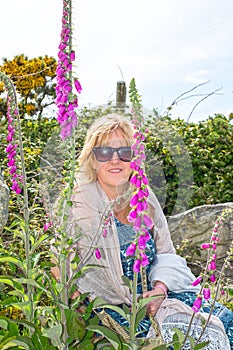 Middle aged woman among wild fox gloves