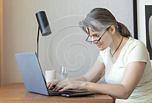 Middle aged woman working at home