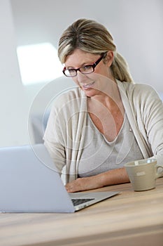 Middle-aged woman working on laptop