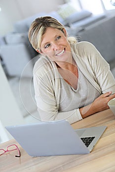 Middle-aged woman working on laptop