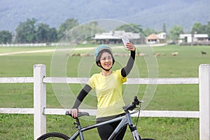 Middle aged women take self photo on her bicycle